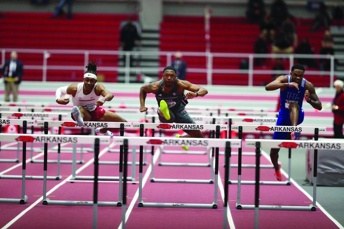 Jesse Henderson, a current junior at Mississippi State University, jumps over a hurdle during a match at the Southeastern Conference Indoor Championships in Fayetteville, Arkansas, where he finished fifth for the Bulldogs during the 60m hurdle finals.