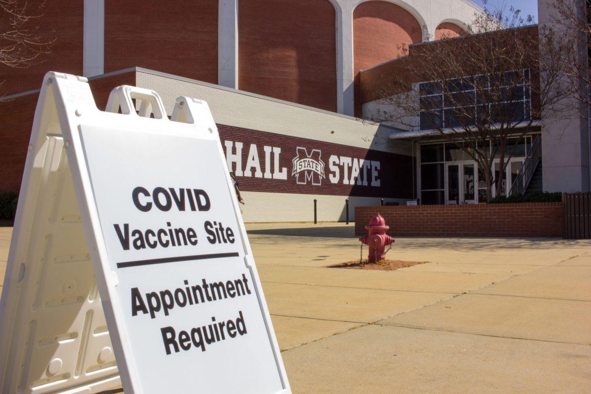 A sign posted outside the Humphrey Coliseum at Mississippi State University points students and faculty toward the COVID-19 vaccination site.