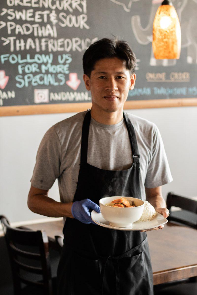 The owner of Andaman Thai, Vien Vong, is pictured with traditional yellow curry.