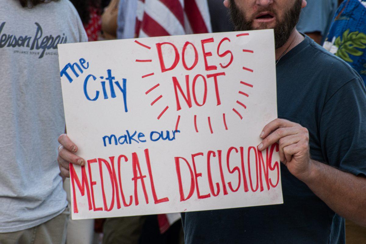 Starkville residents gather outside of City Hall Tuesday afternoon to protest for medical freedom.