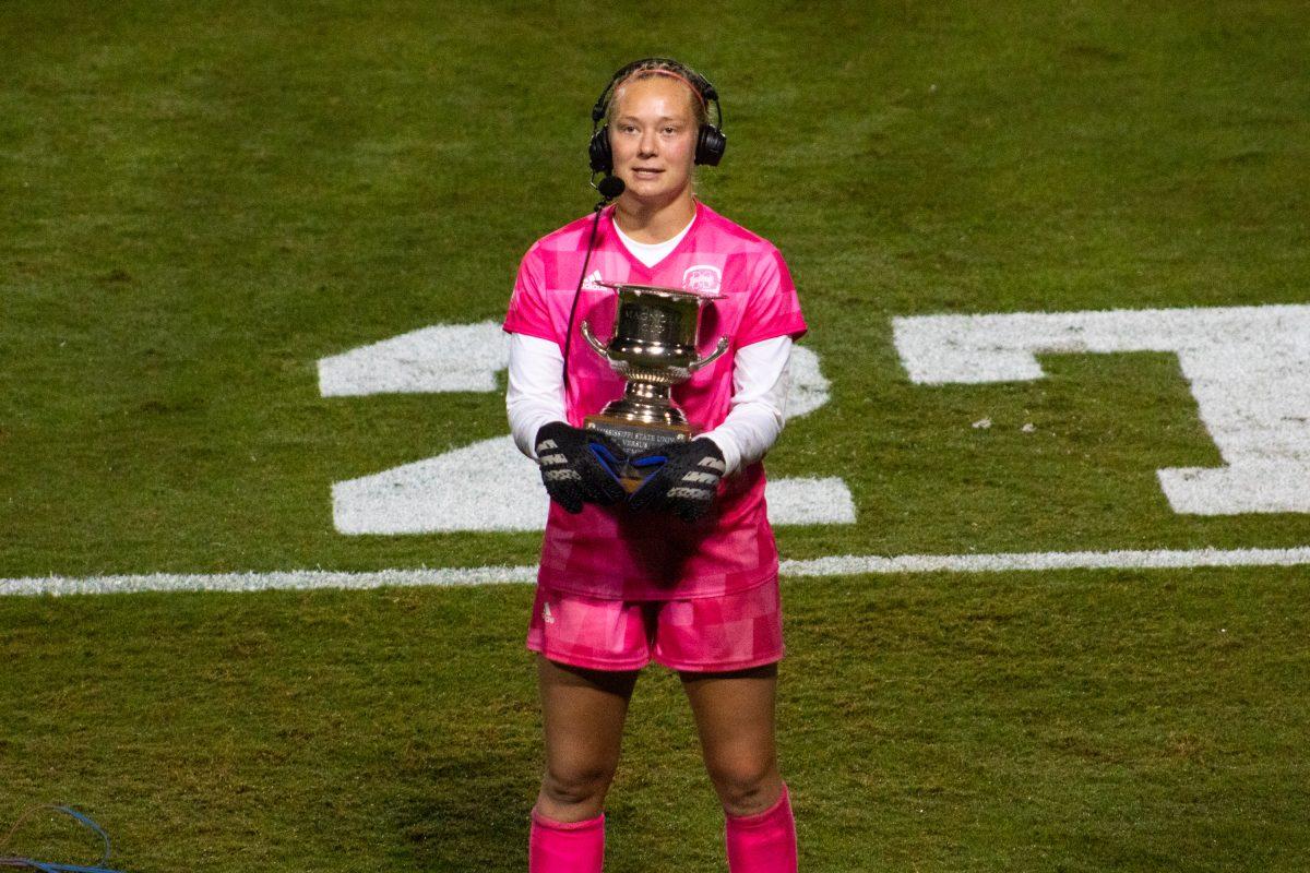 Sophomore goalkeeper Maddy Anderson holds the Magnolia Cup after a comeback win over Ole Miss.