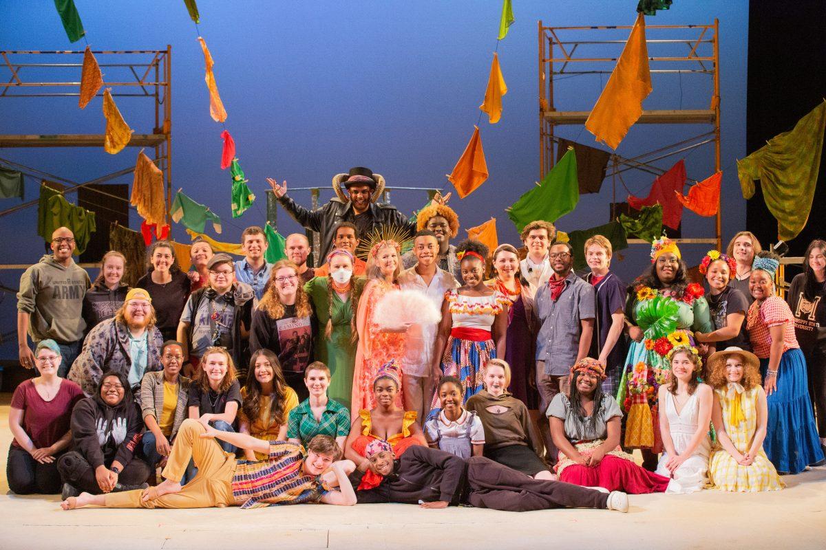 The cast and crew of Once on This Island, a stage musical, poses on the McComas Theatre stage. The play, written by Lynn Ahrens, follows Ti Moune and Daniel Beauxhomme as Ti fights for Daniel’s love.
