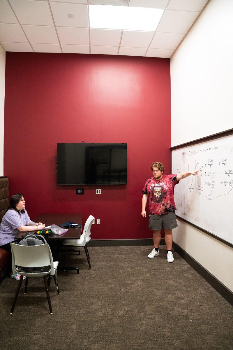 Two students work in room 1100 of the Old Main Academic Center, one of 14 study rooms available for use in the building.