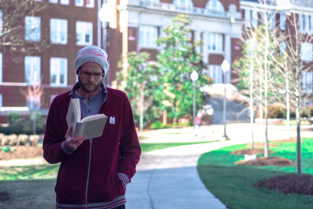 Walk-reader Will Malone strolls around the Drill Field as he devours his latest novel. He has been walk-reading since 2013.