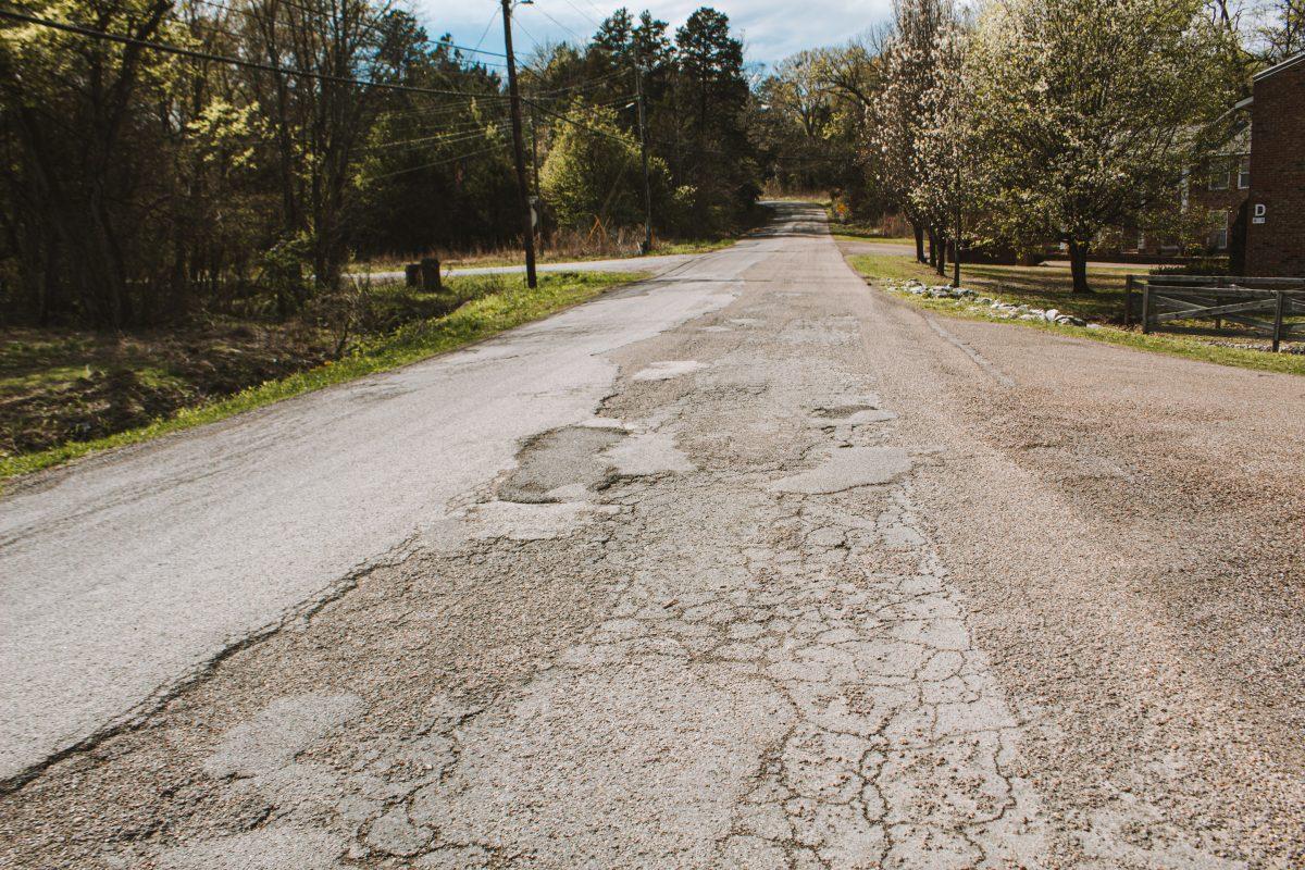 Old Mayhew Road is bumpy and full of potholes and loose gravel