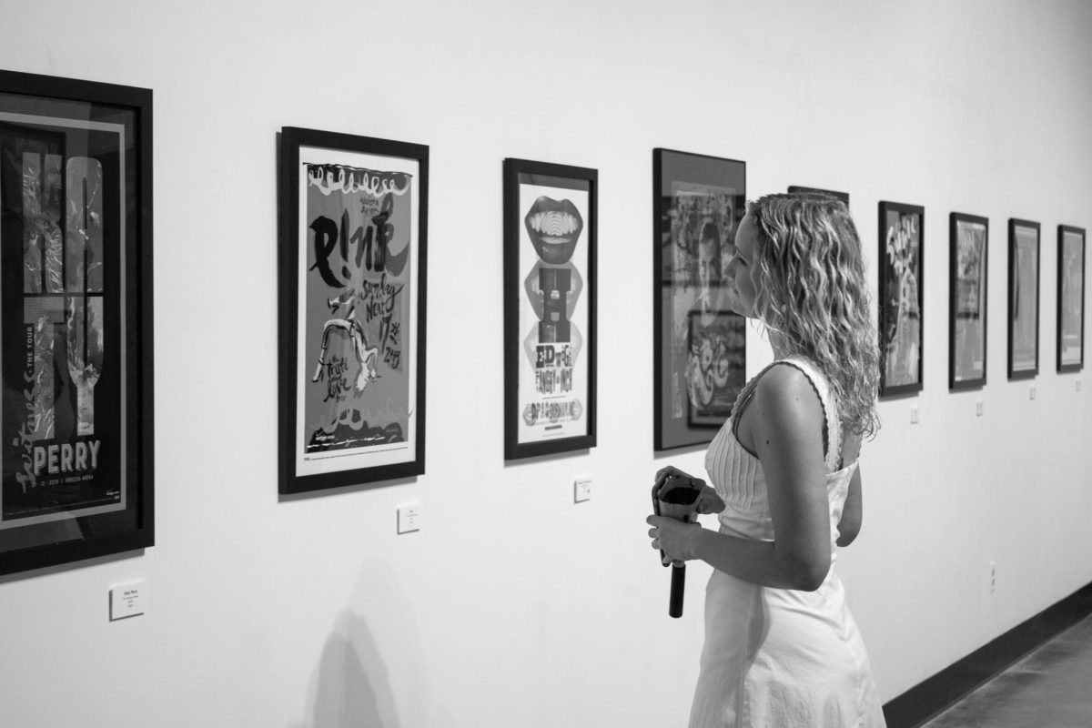 Annie Kirkpatrick, a senior at Mississippi State University, admires the posters made by Mixon