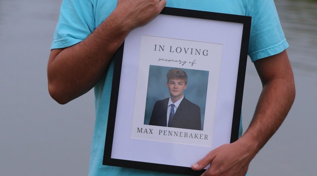 The framed funeral program for Pennebaker was held by a brother throughout the event.