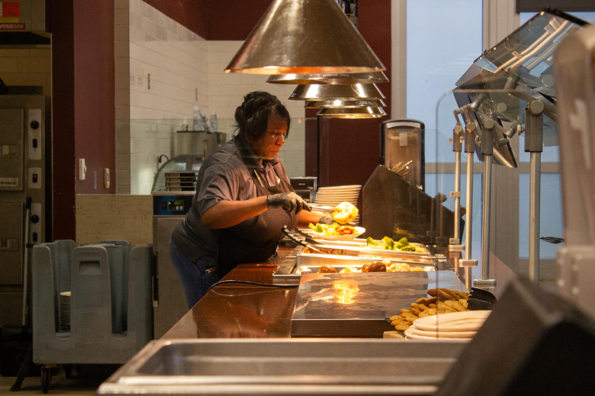 Patricia Brewer prepares food for students at Fresh Food Co.