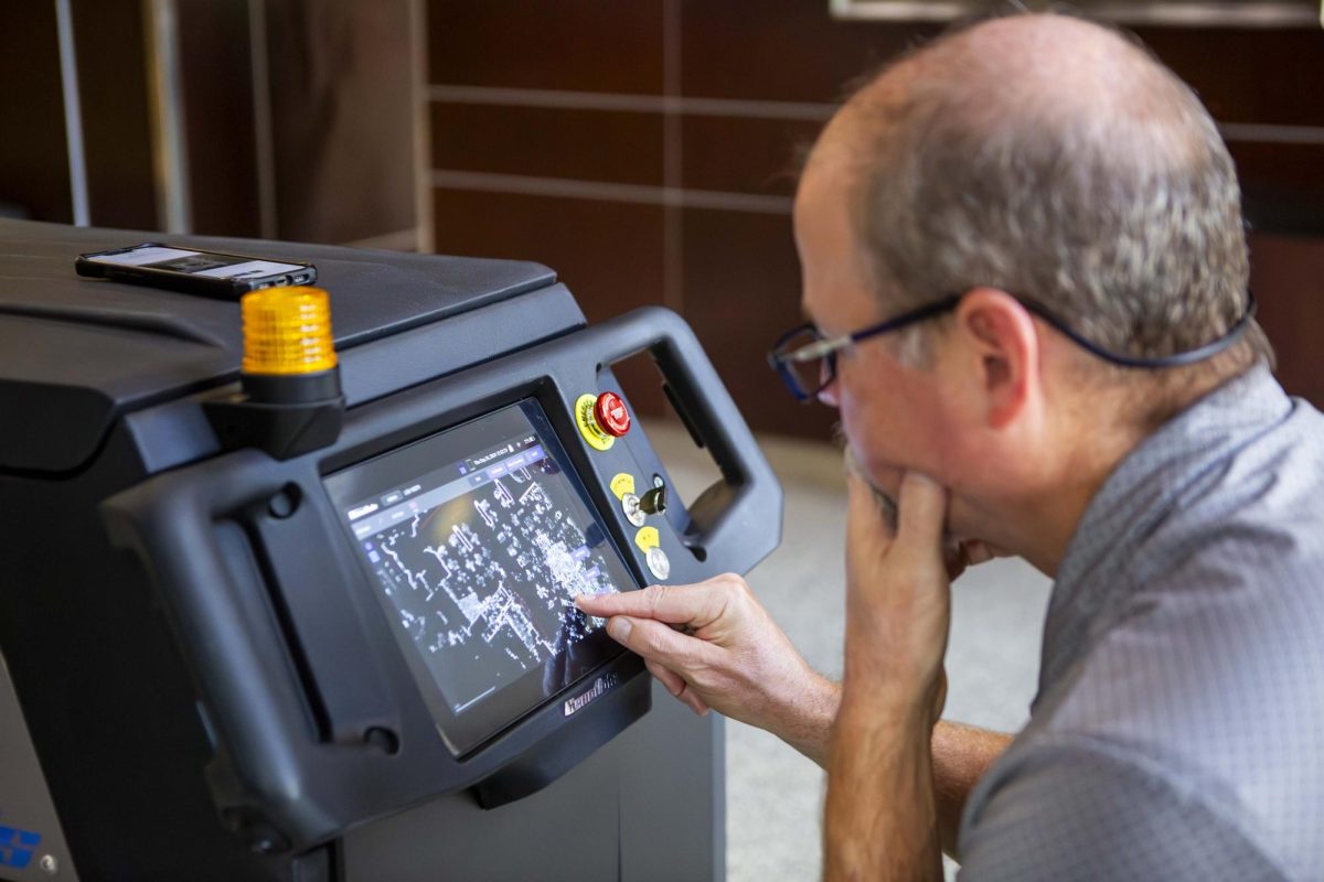 Brian Pfeiffer of Hinton Sales sets up the map on one of the new CenoBots.