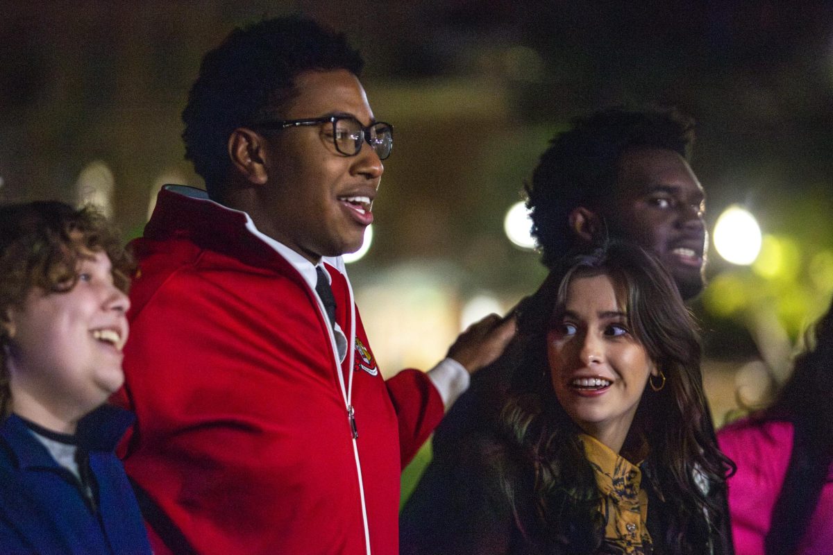 Cameron Cummings and Karolina Heathcock sing the alma mater on Tuesday night. 