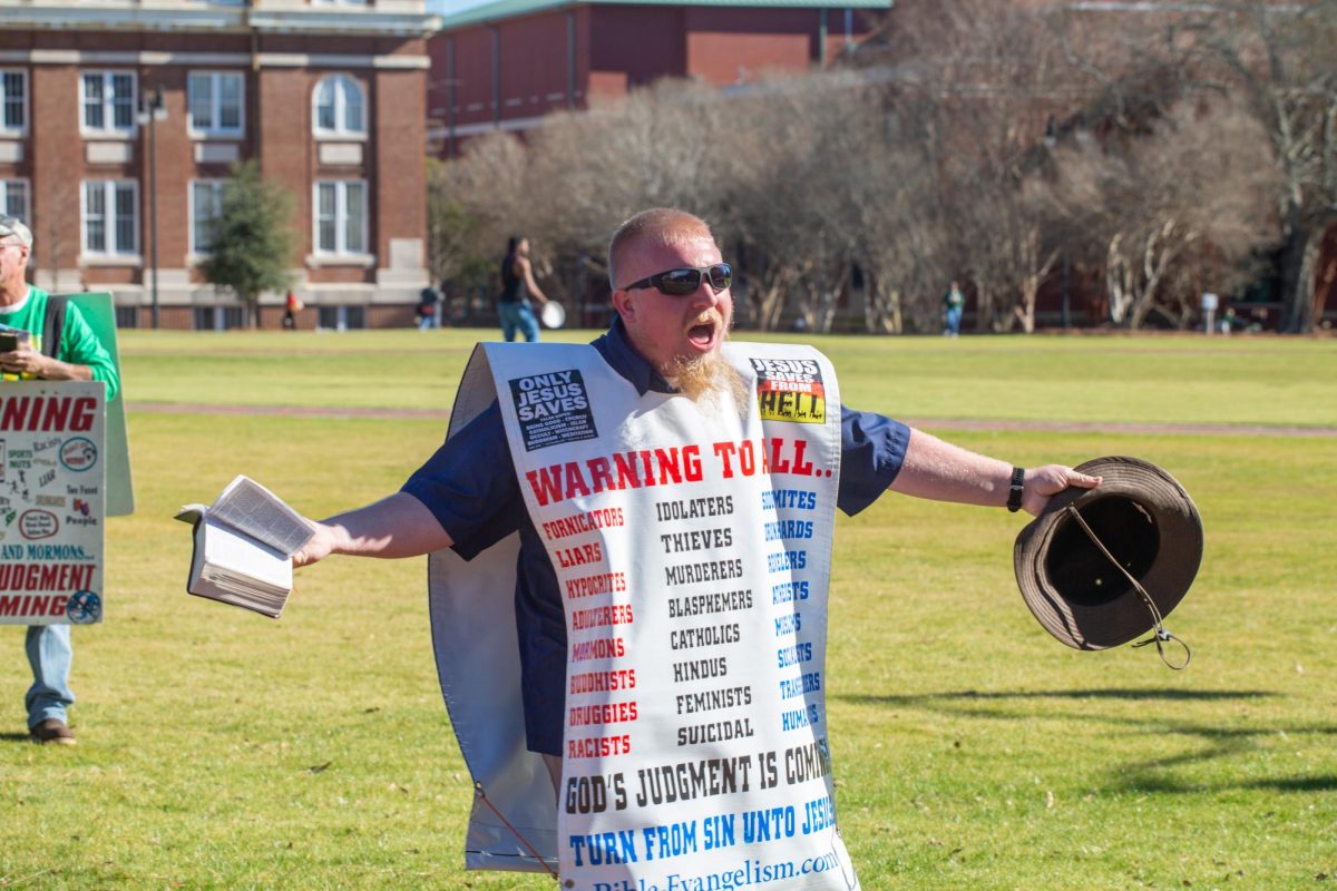 Protesters from Consuming Fire Fellowship preach to students.