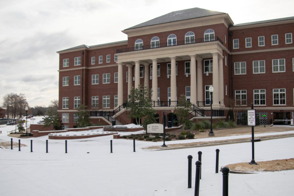 Snow lies on the ground in front of Old Main Academic Center in January 2024.