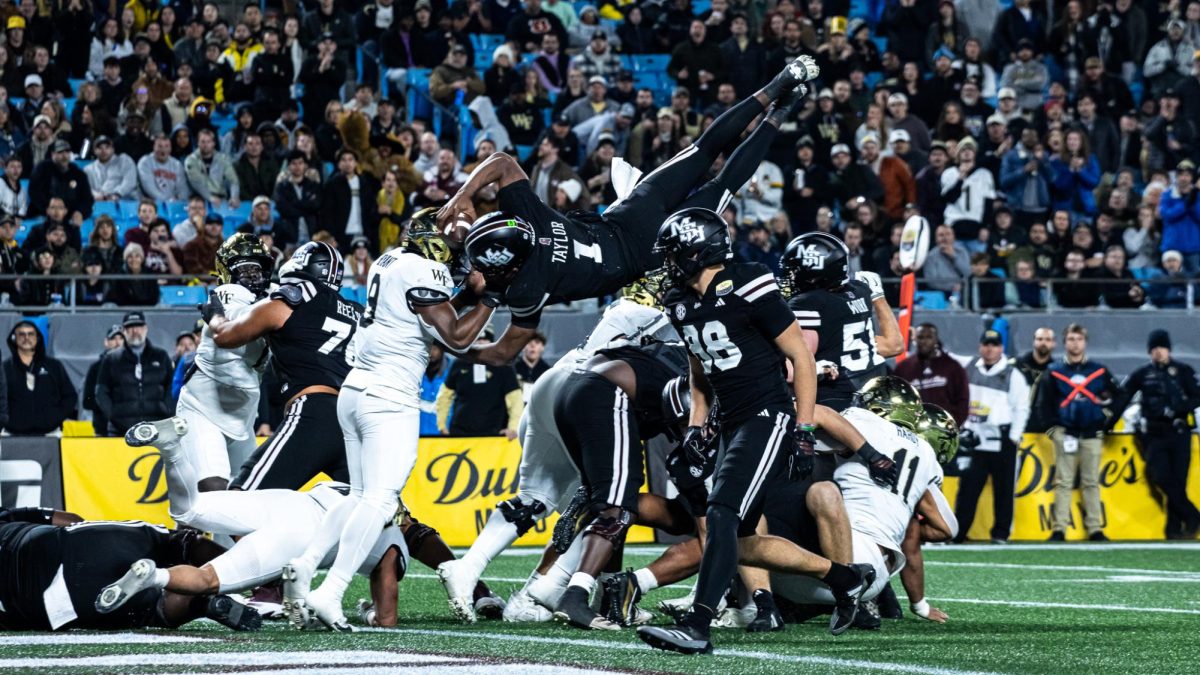 Freshman MSU quarterback Kamario Taylor flies over the other players during the Duke's Mayo Bowl at the Bank of America Stadium in Charlotte, North Carolina. 