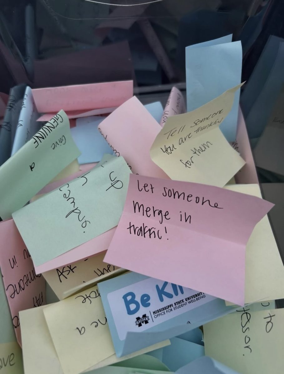 Students wrote kindness challenges on sticky notes during the Office for Student Well-Being kindness week tabling event.