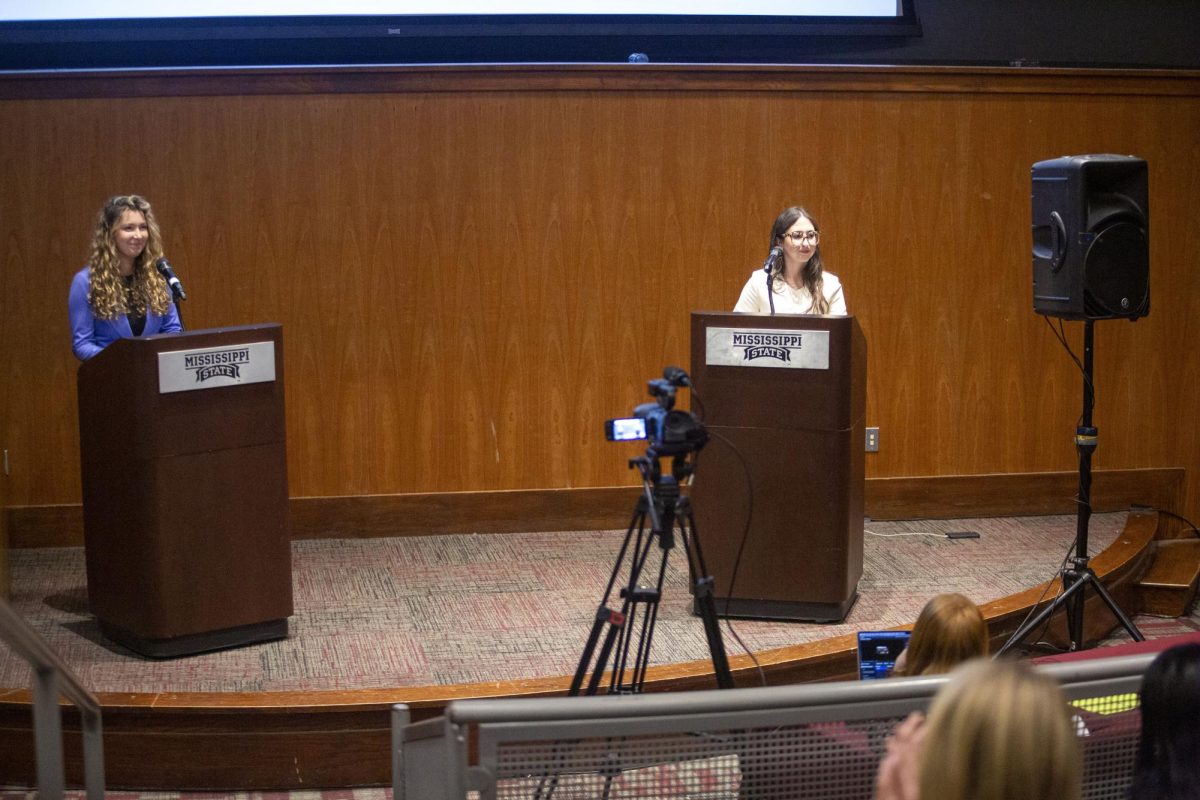 Vice presidential candidates Sydney Broderick and Abigail Spreen listen as moderator Kate Myers asks a question during the debate in McCool Hall on Thursday.