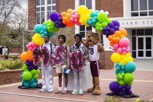 Students pose for a photo with Bully on the YMCA Plaza.