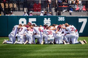 The Mississippi State University Diamond Dawgs join each other in a team huddle before a Southeastern Conference matchup with hopes of a win. 