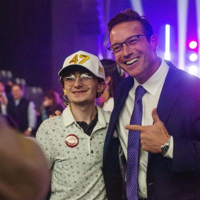 5:13 p.m. - Conservative Political Commentator Benny Johnson poses for a photo with a fan at the TPUSA event.