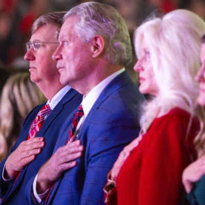 Gov. Tate Reeves stands alongside Chancellor Glenn Boyce during the national anthem on Wednesday.