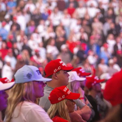 6:43 p.m. - Young Turning Point followers wear "Make America great again" caps as listen as Erika Kirk speaks.