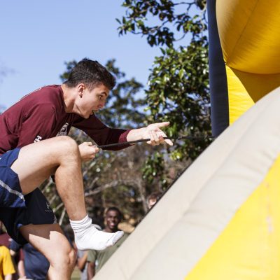 November 22, 2025 - 12:23 PM - An MSU Air Force ROTC Cadet focuses while racing an Ole Miss Cadet on an inflatable obstacle course in Calhoun City.