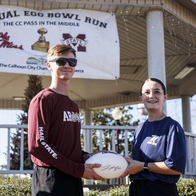 November 22, 2025 - 12:30 PM - Mississippi State Army ROTC Cadet James Jackson smiles for a photo with the game ball signed by Lane Kiffin during the Egg Bowl Run handoff.