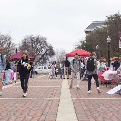 Students walk through the YMCA Plaza as candidates for Student Association seats table.
