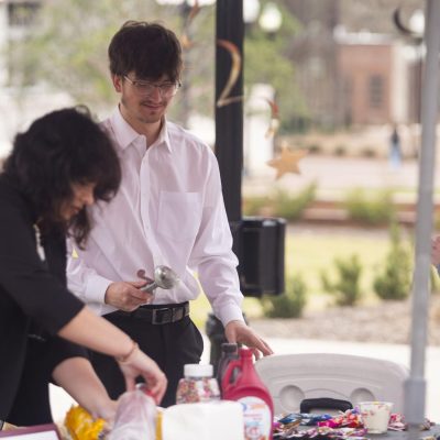 Peyton Willoughby scoops Bop's custard as he campaigns for the Student Association treasurer position on Tuesday.