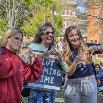 Before the sermon started at noon, Smock took pictures with the crowd, including, by request, flashing the Alpha Chi Omega sorority's sign.